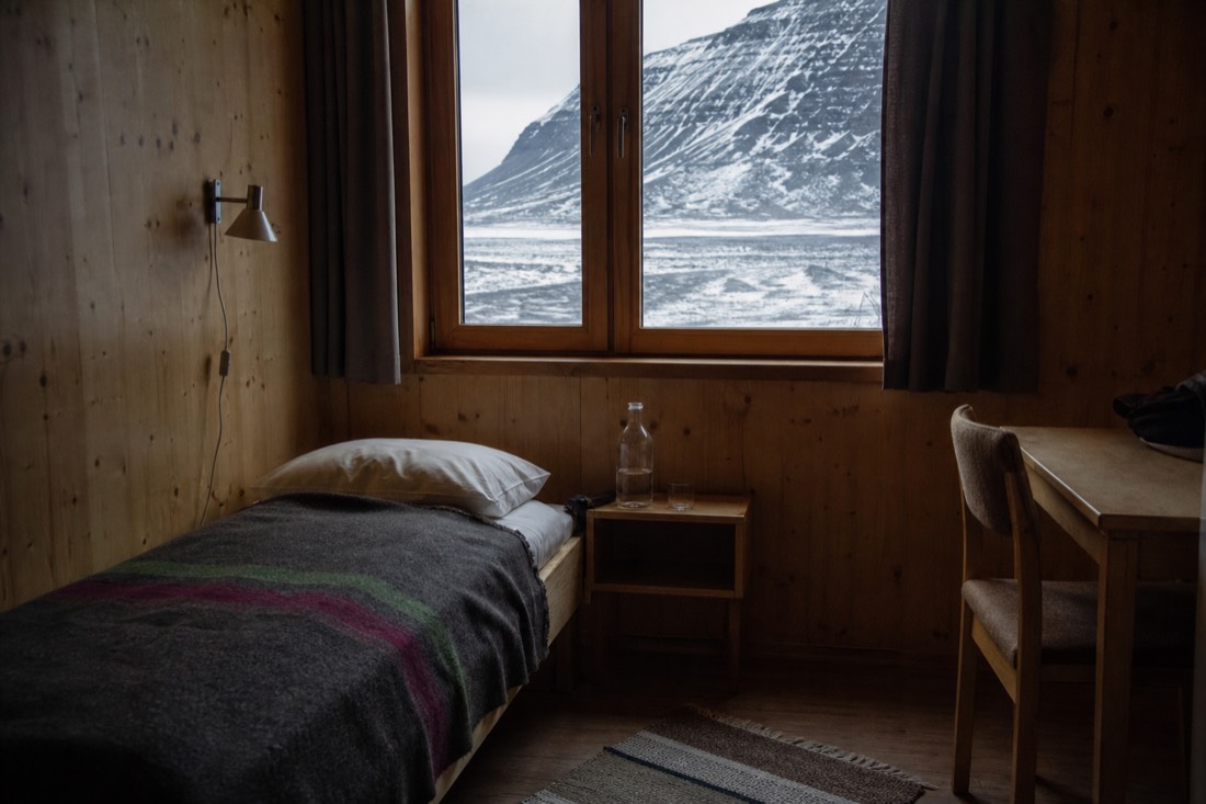 Simple timber guesthouse room in Longyearbyen, the accommodation floor that has no hostel tier beneath it